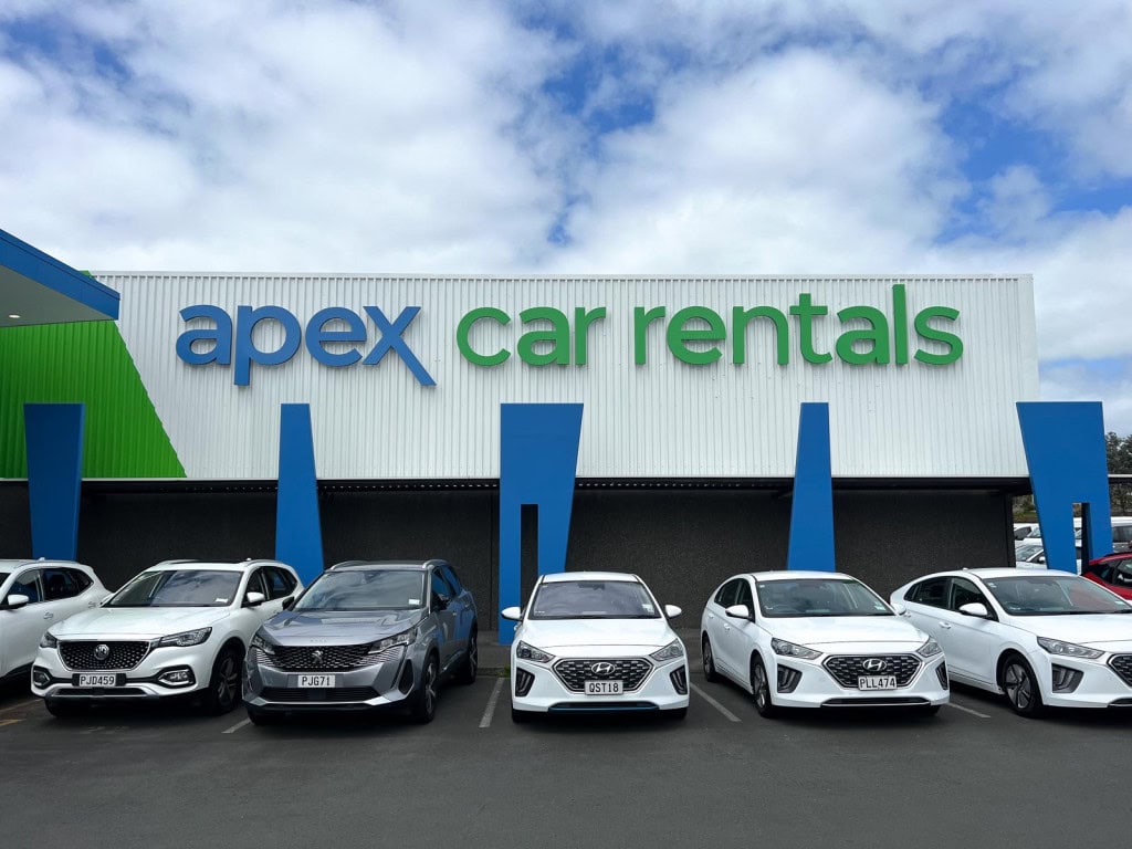 Rental cars lined up in front of the Apex Rentals depot in Auckland.