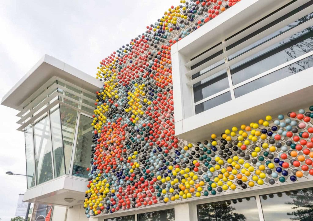 The front of the MTG Hawke's Bay Museum, with colourful pin sculptures dotting a wall of the building.