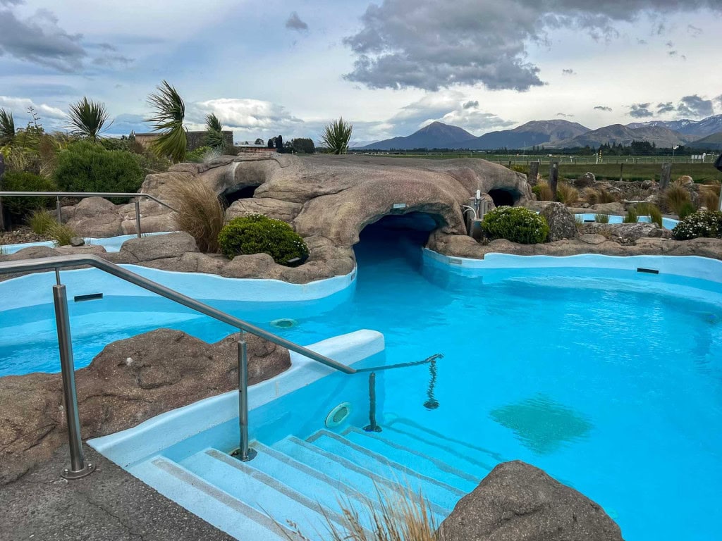 Stairs leading to a hot pool with a cave at the Opuke Thermal Pools in Methven.