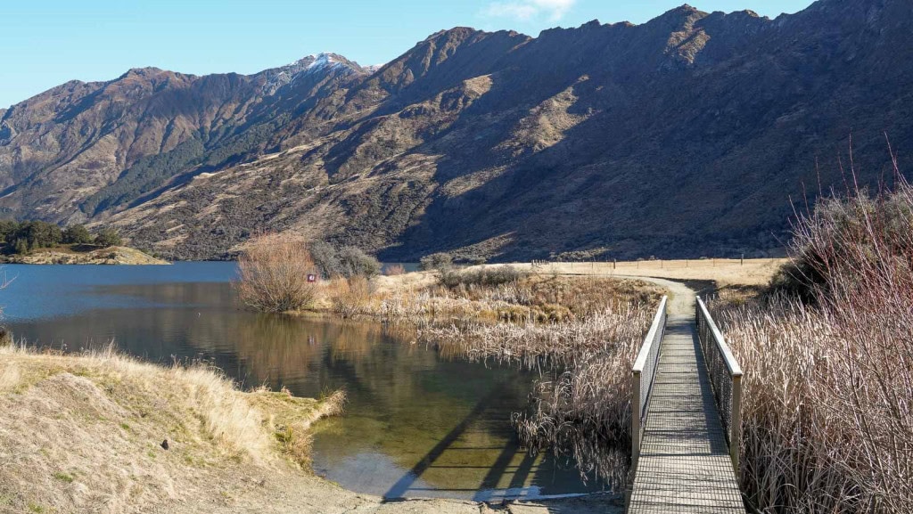 A small wooden bridge at the start of the Moke Lake Loop Track.